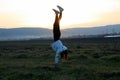 She is doing handstand