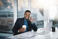 Doing his round of calls to close some deals. a handsome young businessman talking on a cellphone while working in an