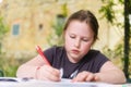 Doing homework in the quarantine of the garden in front of the house in sunny spring Royalty Free Stock Photo