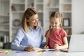 Doing Homework Together. Loving Young Mother Helping Her Little Daughter With Study Royalty Free Stock Photo