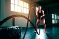 Doing intense hard training with rope at gym Royalty Free Stock Photo