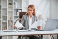 Doing paperwork. Woman in business formal clothes is working in office Royalty Free Stock Photo