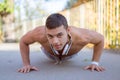 Doing push-ups pushups exercising sports training fitness workout young latin man