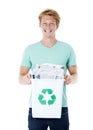 Doing the responsible thing. A friendly young red-headed man holding a recycling bin filled with newspapers. Royalty Free Stock Photo