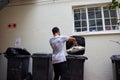 Doing the responsible thing. Shot of a young man putting newspaper in the bin to be recycled.