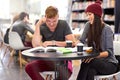 Doing some exam prep with a friend. two college students studying together at the library.