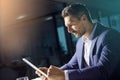 Doing some light night research. a businessman using a digital tablet while woking late at the office. Royalty Free Stock Photo