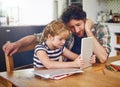 Doing some online research for her homework assignment. a father helping his daughter complete her homework on a digital Royalty Free Stock Photo