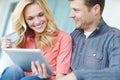 Doing some shopping together. a happy mature couple shopping online using a digital tablet while relaxing together at Royalty Free Stock Photo