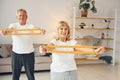 Doing stretching and fitness exercises. Senior man and woman is together at home Royalty Free Stock Photo
