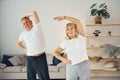 Doing stretching. Senior man and woman is together at home Royalty Free Stock Photo