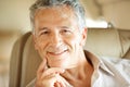 Doing things in style. Portrait of a handsome senior man sitting in an airplane - closeup. Royalty Free Stock Photo