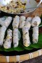 Doing Vietnamese vegetarian dish, make deep fried corn spring roll, vegan food in leaf background