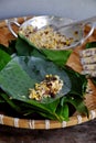 Doing Vietnamese vegetarian dish, make deep fried corn spring roll, vegan food in leaf background