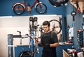 Doing what he does best, bicycle repair. a man working in a bicycle repair shop. Royalty Free Stock Photo