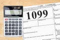 Doing your taxes as a freelancer with a calculator with a 1099 form Royalty Free Stock Photo