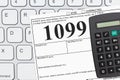 Doing your taxes as a freelancer with a 1099 form on a keyboard Royalty Free Stock Photo