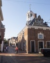 Woman on bicycle next to waag building in old frisian town of dokkum Royalty Free Stock Photo