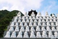 Dol Harubang and Buddha sculptures in a row at Sanbanggulsa temple, Sanbang-ro, Jeju Island, South Korea