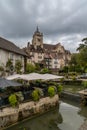 Vertical view of the city center of Dole with the Notre Dame Church and the canals on the Doubs River under an overcast sky