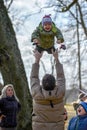 DOLE, LATVIA - MARCH 27, 2016: Easter holidays. Unknown Man throws children into the air