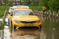 Yellow taxi vehicle stuck in flooded road