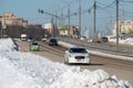 Cars driving at clean highway after serious snow stowm in region