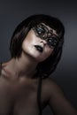 Doll, beautiful brunette with short hair and Venetian mask, cabaret