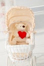 Doll buggy vintage with teddy bear and red heart Royalty Free Stock Photo