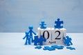 Doll children background with symbolic autism puzzle pieces and calendar