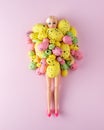 Doll with colorful Easter eggs on pastel pink background. Minimal spring holidays concept