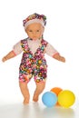 A doll cute little girl in colorful clothes with colorfull balloons