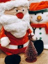 Doll cute santa claus and red christmas tree decorated celebrate the Christmas festival.
