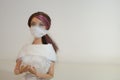 Doll with face mask and hospital supplies closeup on white background