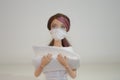 Doll with face mask and hospital supplies closeup on white background