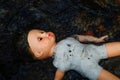 Doll floating in river Royalty Free Stock Photo
