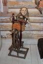 Doll - girl with a spinning wheel in a Russian hut, in a children's park in Kostroma