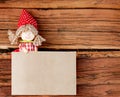 Doll Holding a Copy Space Made of Paper. Vintage Wooden Background
