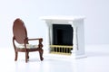 Doll house interior - armchair next to fire place isolated on white background Royalty Free Stock Photo