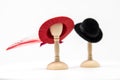 Doll House Mens and Women's Fashion Hats on small hat stands wit