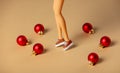 doll legs and small Christmas baubles next to her Royalty Free Stock Photo