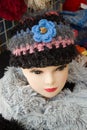 Doll modelling feathery shawl and knitted headdress