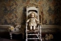 doll propped up on an antique rocking chair Royalty Free Stock Photo