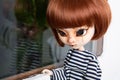 Doll red hairs face expressive portrait with big eyes standing window pretty fashion girl