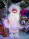 Doll Santa Claus in white with gifts and animals