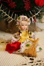 Doll sitting with a broom and dustrag. Royalty Free Stock Photo