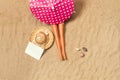 A doll under an umbrella on the sand taking a sunbath