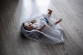 Doll in wedding dress is lying on the floor. Symbol of abandoned bride, canceled wedding. Soft focus, sad view. Royalty Free Stock Photo