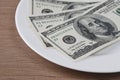 Dollar bank note money in the white plate Royalty Free Stock Photo