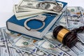 Dollar banknotes with handcuffs on blue book Royalty Free Stock Photo